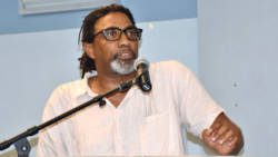 University of the West Indies lecturer Tennyson Joseph delivers his review of St. Vincent and the Grenadines’ Minister of Finance, Camillo Gonsalves’ book Globalised. Climatised. Stigmatised. in Calliaqua on Monday. (Photo: Lance Neverson/Facebook)
