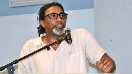 University of the West Indies lecturer Tennyson Joseph delivers his review of St. Vincent and the Grenadines’ Minister of Finance, Camillo Gonsalves’ book Globalised. Climatised. Stigmatised. in Calliaqua on Monday. (Photo: Lance Neverson/Facebook)