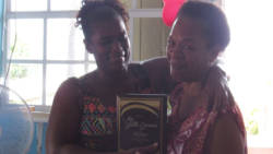 Judy Baptiste presented a plaque of appreciation to retired nurse Yvette Greaves, of Owia.