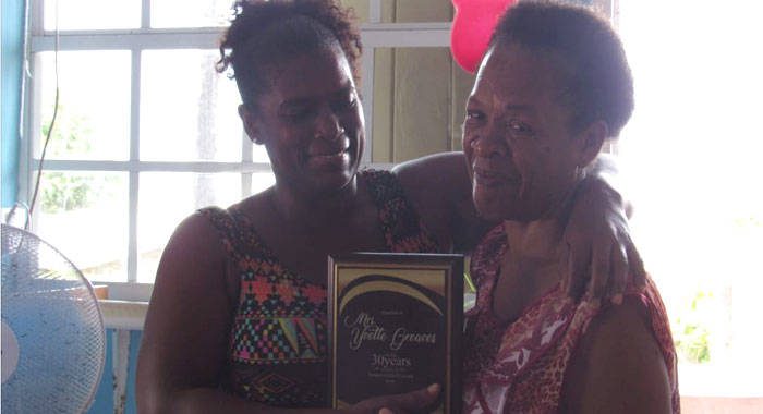 Judy Baptiste presented a plaque of appreciation to retired nurse Yvette Greaves, of Owia.