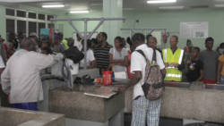 Persons wait to buy fish at the Kingstown Fish Market on Monday, Fisherman's Day. (iWN photo)