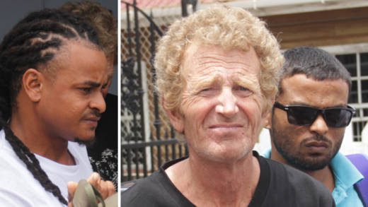 From left: Kenroy Edwards, of Rose Bank, Kevin Slauter, of England, and Javid Chetram, of Grenada, leave the Kingstown Magistrate’s Court on Friday. (iWN photo)