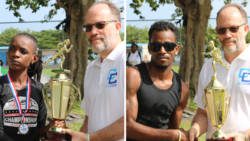 Vincentian athletes Linda Mc Dowald and Junior Ashton receive their trophies from CARICOM CARICOM Secretary-General Irwin LaRocque.