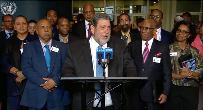 Prime Minister Ralph Gonsalves, speaks to the media at the United Nation last week as members of his delegation and staff at  SVG's UN Mission look on.