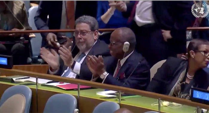 Prime Minister Ralph Gonsalves, left, and Deputy Prime Minister Sir Louis Straker applaud after the announcement of the results at the United Nations on Friday. Kingstown’s permanent representative to the UN, I. Rhonda King is at right.