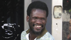 Daniel Laidlow smile as he leaves the Kingstown Magistrate's Court last Wednesday after paying compensation for punching the mother of his child in the eye two days earlier. (iWN photo)