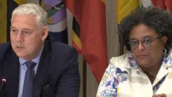 Prime Minister Allen Chastanet, left, and Mia Mottley speaking at the press conference in Castries Friday night. (iWN photo)