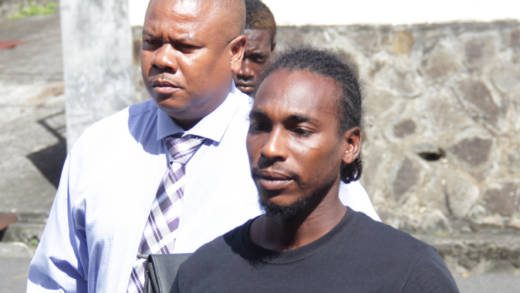 Attempted murder accused Romando Bruce, right, is escorted to court by the lead investigator, Detective Corporal Dwight James, on Wednesday. (iWN photo)