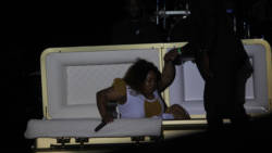 Shaunelle McKenzie is assisted out of the casket at Dimanche Gras at Victoria Park. She went on to capture the calypso crown. (iWN Photo)