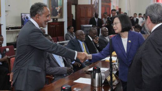 Opposition Leader Godwin Friday, left, shakes hands with President of Taiwan, Tsai Ing-wen after her address to Parliament during an official visit to St. Vincent and the Grenadines on July 16, 2019. Prime Minister Ralph Gonsalves is at left. (iWN photo)
