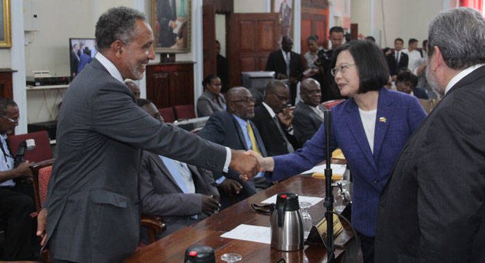 Opposition Leader Godwin Friday, left, shakes hands with President of Taiwan, Tsai Ing-wen after her address to Parliament during an official visit to St. Vincent and the Grenadines on July 16, 2019. Prime Minister Ralph Gonsalves is at left. (iWN photo)