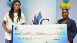 Soneek James, right, sister of Sauhil "Freddy" James, collects first prize cheque from Odini Sutherland, Coreas Hazells Marketing Manager.