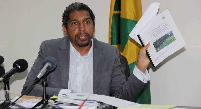 Minister of Finance Camillo Gonsalves holds up the bid evaluation report at a press conference in Kingstown on Tuesday. (iWN photo)