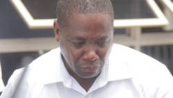 Security guard Kensley Bascombe cries as he is escorted to prison on Tuesday. (iWN photo)