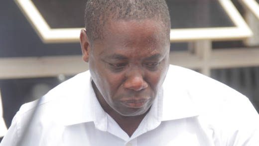 Security guard Kensley Bascombe cries as he is escorted to prison on Tuesday. (iWN photo)