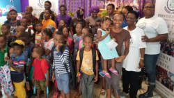 Some of the members of the foundation along with the recipients of the backpacks and their parents. 