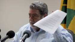 Prime Minister Ralph Gonsalves holds up a document at the press conference on Tuesday. (iWN photo)