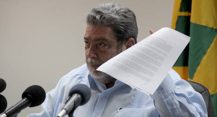 Prime Minister Ralph Gonsalves holds up a document at the press conference on Tuesday. (iWN photo)