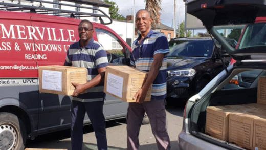 Members of the group load the 18 cartons of bed linen into a van to take to the docks.