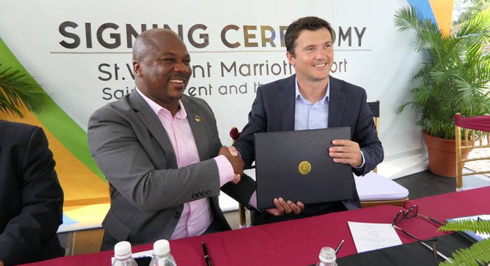 Manager of National Properties Ltd., Hans King, left, shakes hands with Bojan Kumer, Marriott International’s vice president for hotel development -- Caribbean and Latin America, after signing the management contract. (Photo: Discover SVG/Facebook) 