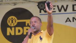 The New Democratic Party's Ben Exeter holds up a cell phone at the party's convention rally on Sept. 29. (iWN Photo)