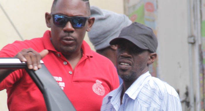 Detective Sergeant Biorn Duncan, left, escorts Louie Cupid, to the Serious Offences Court in October 2019. (iWN photo)