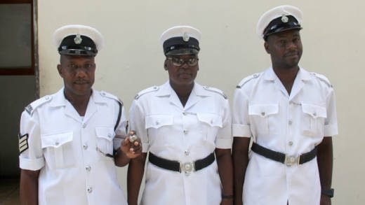 From left: Sergeant Giles and Police Constables Wright and De Roche outside the Serious Offences Court on Tuesday. (iWN photo)