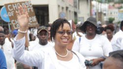 Lawyer Mandella Campbell raises her hand in praise during the march and rally in Kingstown on Thursday. (iWN photo) 