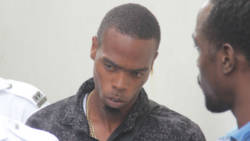 The accused, Shammai Hazell of Bequia waits to be escorted to prison in Kingstown on Monday. (iWN photo)