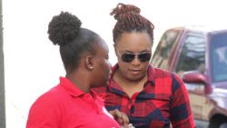 Theft and corruption accused, Mitra-Ann Prescott, right, interacts with a detective on their arrival at the Serious Offences Court on Monday. (iWN photo)