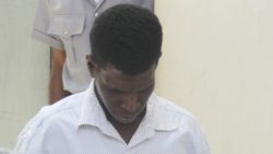 The accused, Tyson Spencer holds down his head as he is escorted to prison on Monday. (iWN photo)
