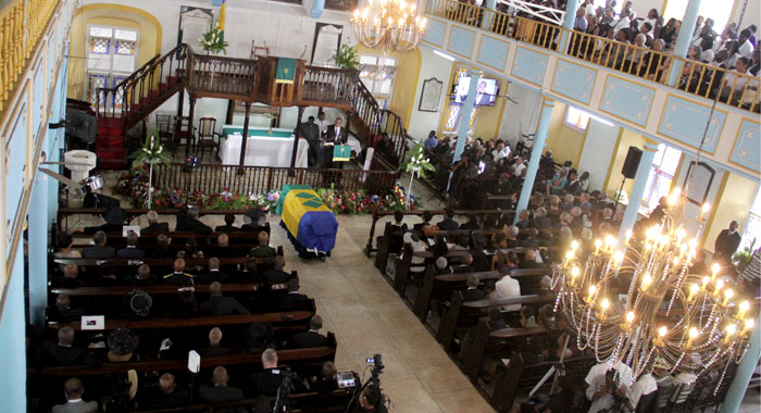The flag-draped casket inside a packed Kingstown Methodist Church. (iWN photo)