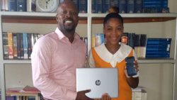 Director of Generation Next Inc., Carlos James hands over a laptop and mobile phone to community college student, Vashica Pereira on behalf of Generation Next Inc. and Brisha Enterprises.