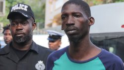 Corporal Nigel John, who led the operation that netted the AR-15 firearm escorts the defendant, Evander Myers to court last Friday. (iWN photo)
