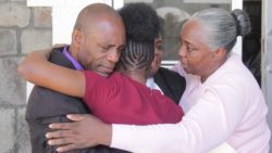 Freed parents Nigel and Althia Morgan weep outside High Court No. 1 in Kingstown, as they embrace their daughter, Krystal Morgan, who returned to prison on Tuesday to complete a reduced sentence for grievous bodily harm. (iWN photo)