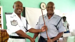 Station Sergeant Brenton Smith, left, symbolically hands over the chairmanship to his successor, Corporal Lez Harry.