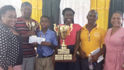 Zaheim Michael poses with his father Ian Michael, teachers and speech coaches as well as Principal of Fancy Government School, Wendy Child, who is at left.