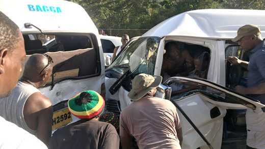 Margaret "Ole Gyal" Smith of Petit Bordel hollers in pain as persons try to free her from the vehicle. (iWN photo)