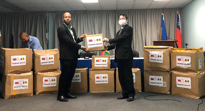 Minister of Health, Senator Luke Browne, left, receives the donation from Taiwan Ambassador Calvin Ho.