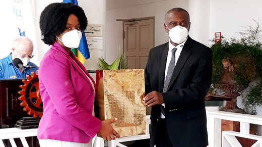 Leanna James, deputy comptroller of Customs & Excise, left, receives masks from President of the Rotary Club of St. Vincent, Reuben John. 