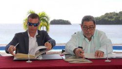 Adam Stewart, deputy chairman of Sandals Resorts International, left, and Prime Minister Ralph Gonsalves the signing ceremony in July. (iWN photo)