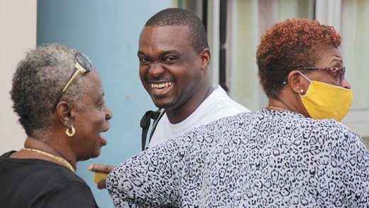 The accused, Kenson King, centre, outside the Kingstown Magistrate's COurt after securing bail on Thursday. (iWN photo)