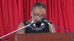 Jerry S. George's widow, Valerie George, pays tribute to him at his funeral on Saturday. (iWN photo)
