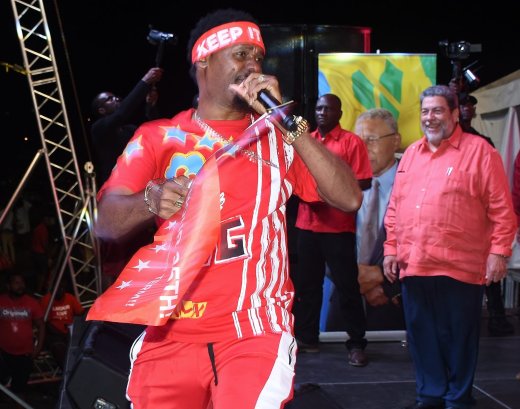 Luta performs at a rally of the ruling Unity Labour Party in September 2020, as Prime Minister Ralph Gonsalves, right, looks on.