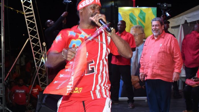 Luta performs at a rally of the ruling Unity Labour Party in September 2020, as Prime Minister Ralph Gonsalves, right, looks on.
