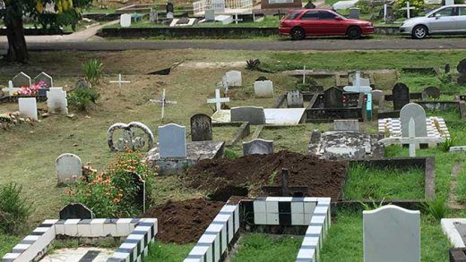 This new grave, located near two roadways in the cemetery, has been prepared for the burial on Wednesday. (iWN photo)