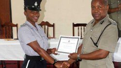 PC996 Sylvorne Lavia, left, receives from Commissioner of Police Colin John the award for the most outstanding police officer on the training course.