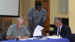 From left: Julian Francis, General Secretary of the ruling Unity Labour Party, Reverend Adolf Davis of the Christian Council, and Opposition Leader Godwin Friday signed the code of conduct on Friday. (iWN photo) 