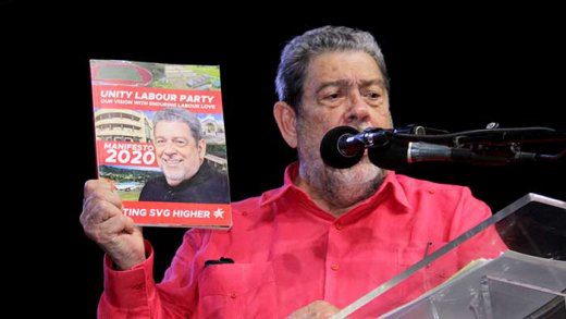 Prime Minister Ralph Gonsalves holds up a copy of the ULP's manifesto at the launch on Sunday. (iWN photo)