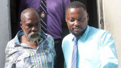 Detective Corporal 191 David, right, escort accused murderer Joffrey James from the Serious Offences Court on Wednesday. (iWN photo)